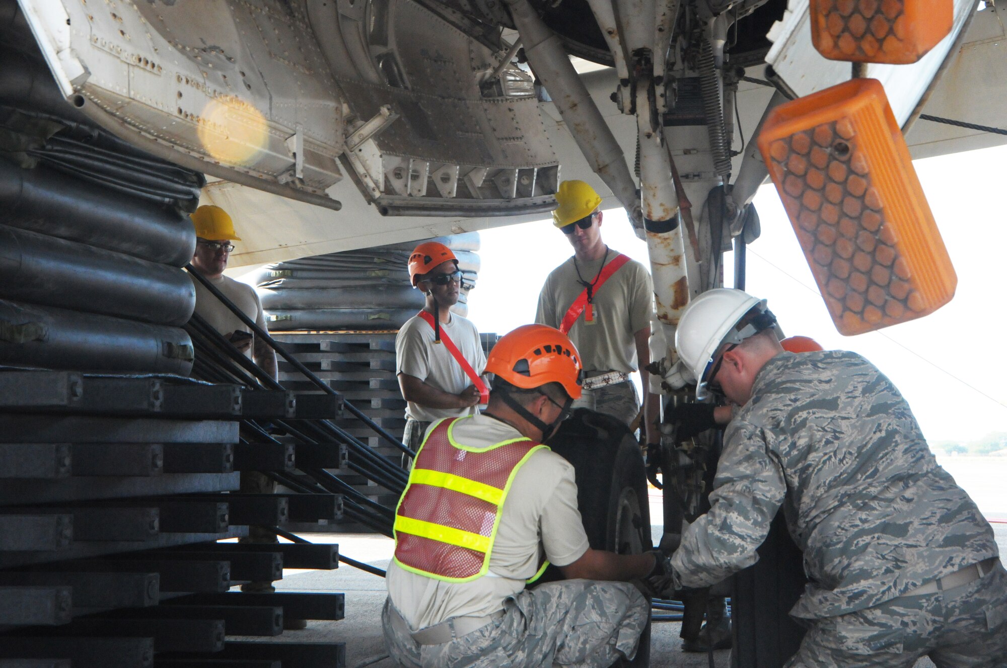 Airmen from the Hawaii Air National Guard 154th Maintenance Squadron and active duty 15th Maintenance Squadron check the stability of landing gear on a lifted P-3 Orion aircraft during a Crash, Damaged, Disabled Aircraft Recovery training exercise, Jan. 27, 2016, Kalealoa, Hawaii. Hickam's CDDAR team is comprised of highly trained and specialized maintainers who work to quickly remove and recover a disabled aircraft with the goal of minimizing additional damage. (U.S. Air National Guard photo by Senior Airman Orlando Corpuz/released)