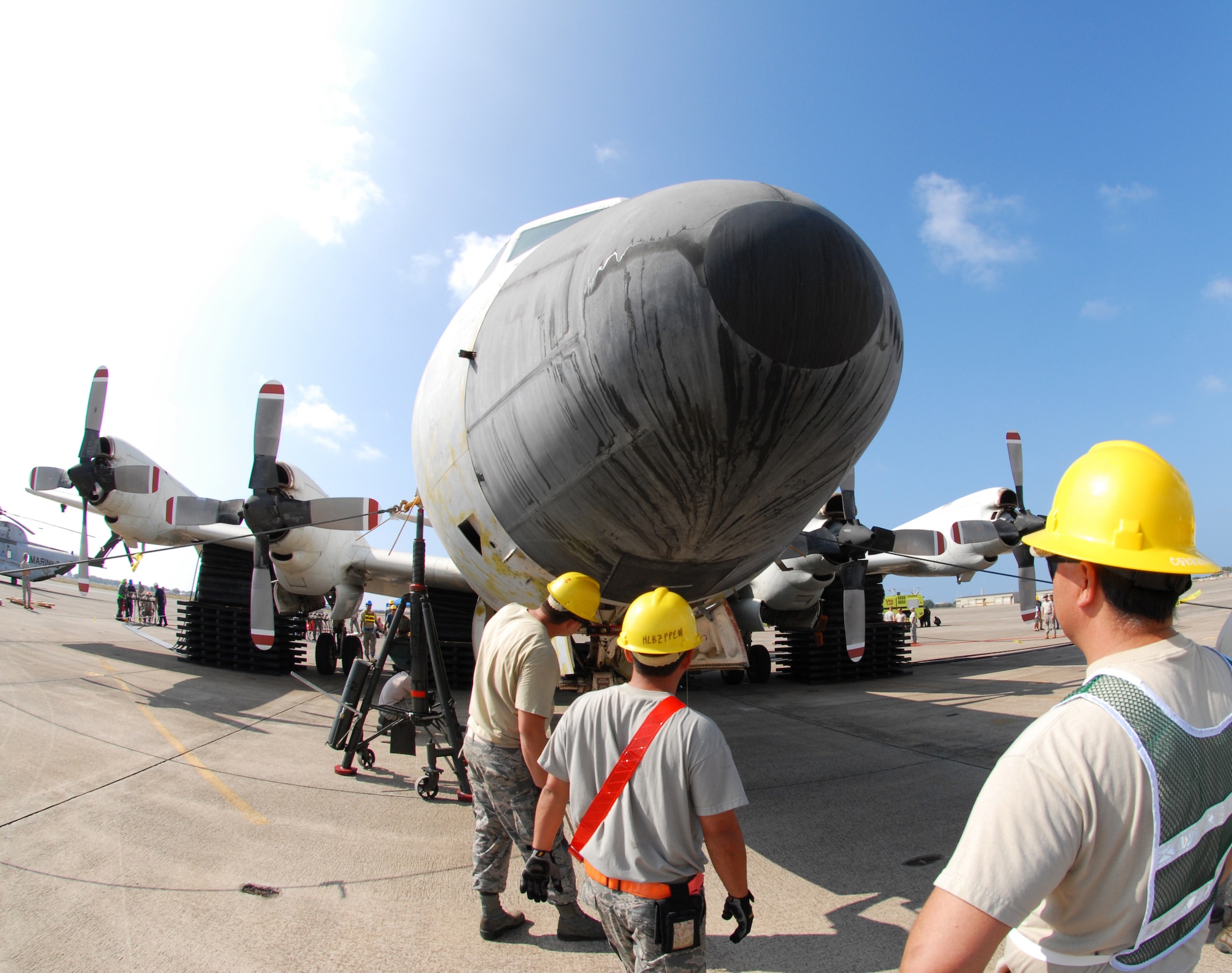 Airmen from the Hawaii Air National Guard 154th Maintenance Squadron and active duty 15th Maintenance Squadron inspect a lifted P-3 Orion aircraft during a Crash, Damaged, Disabled Aircraft Recovery training exercise, Jan. 27, 2016, Kalealoa, Hawaii. Team members utilized a system of specialized air bags and tethering cables to raise the simulated disabled aircraft. CDDAR teams are tasked with safely removing disabled aircraft from areas that interfere with flight operations. (U.S. Air National Guard photo by Senior Airman Orlando Corpuz/released)