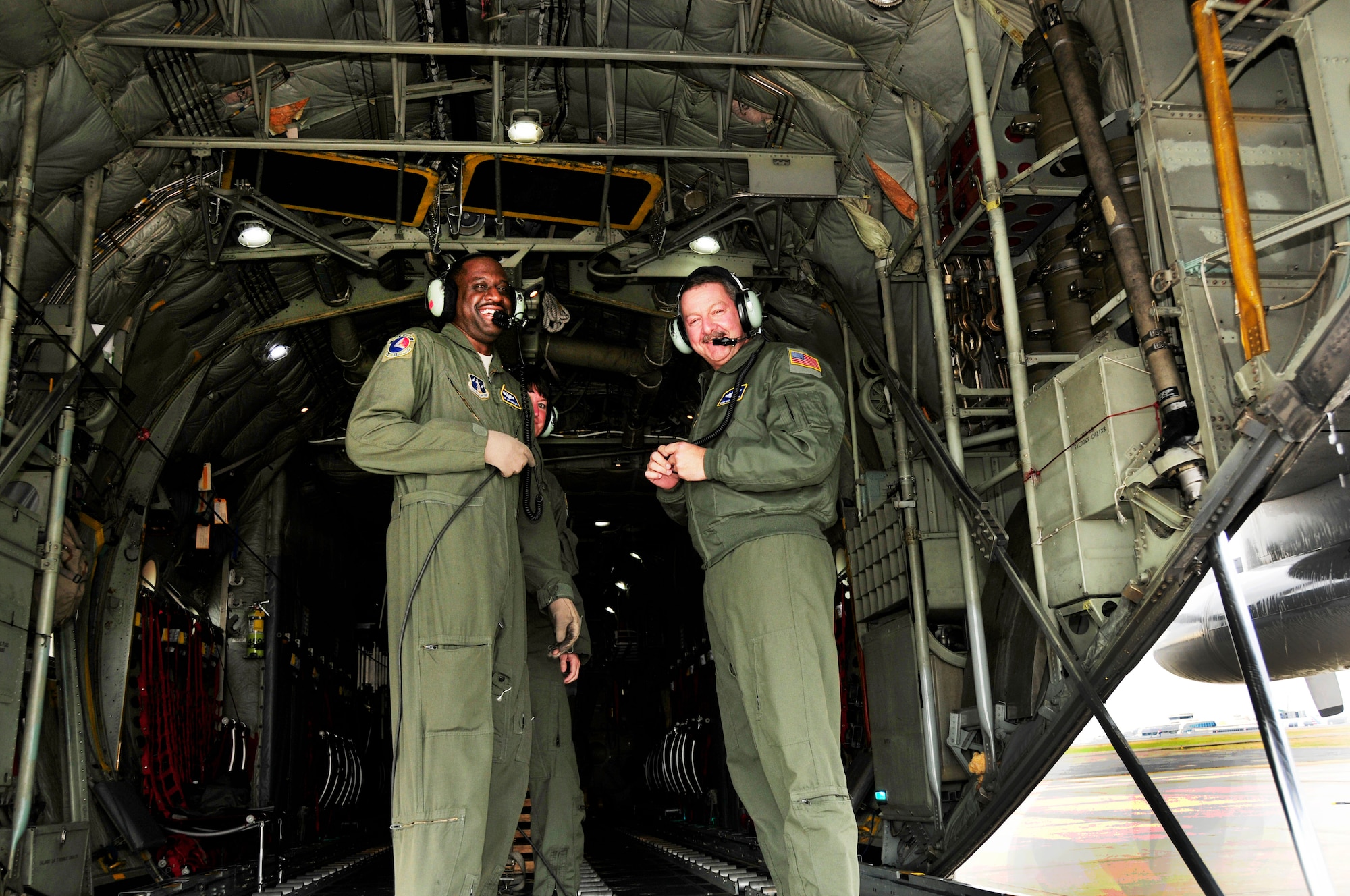 U.S. Air Force Senior Master Sgt. Jermaine Parker (left), Master Sgt. Pennie Brawley (center), and Chief Master Sgt. Andrew Huneycutt, (right) loadmasters for the 145th Airlift Wing, complete post flight checks in the cargo area of a 145th Airlift Wing, C-130 Hercules aircraft after landing at the North Carolina Air National Guard Base, Charlotte Douglas International Airport; December 21, 2015.  For Huneycutt, this would be his final flight before retiring. After serving over 36 years in the NCANG, he steps off the aircraft onto the tarmac for the last time. (U.S. Air National Guard photo by Master Sgt. Patricia F. Moran/Released)