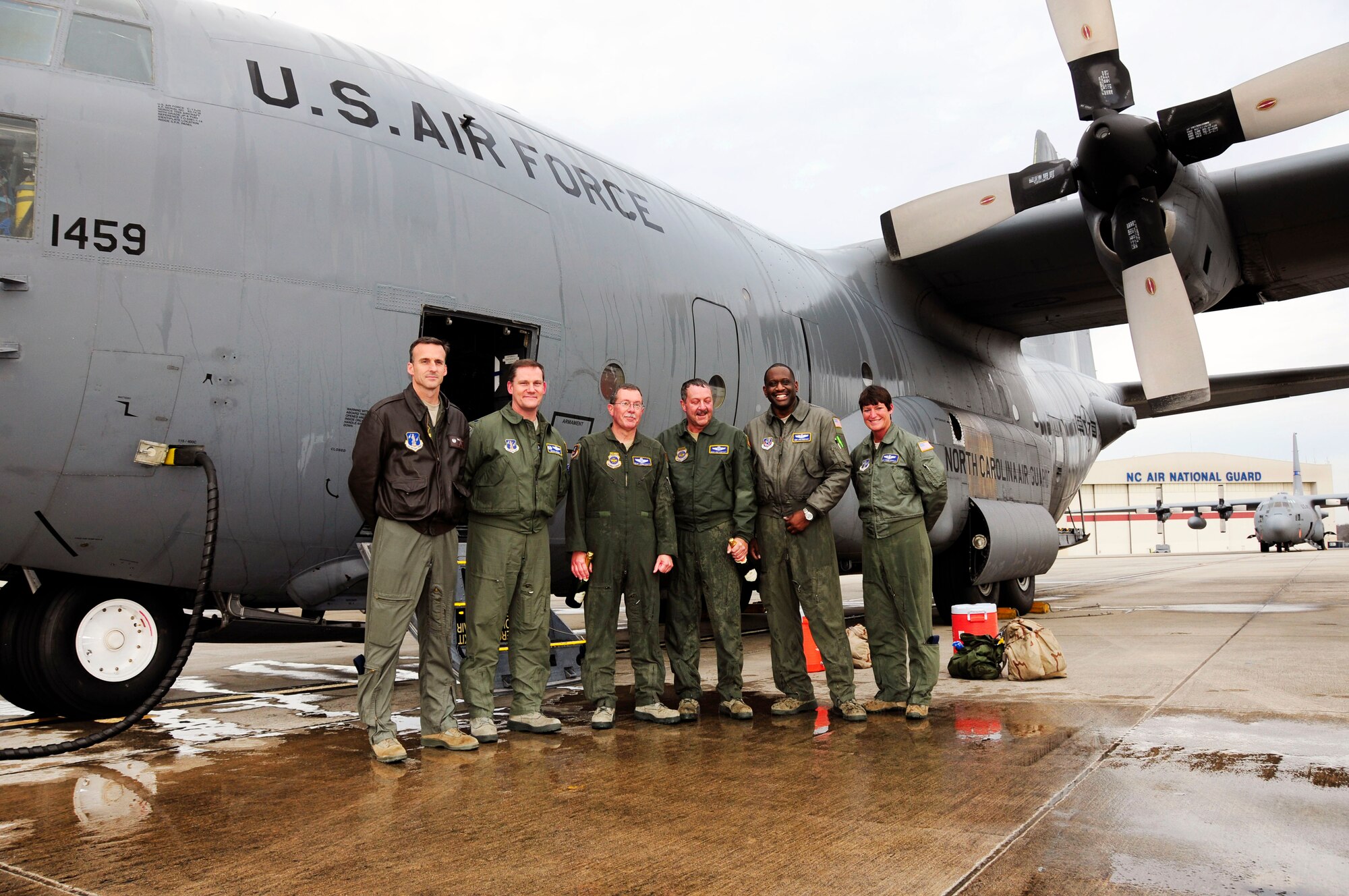 U.S. Air Force Col. Quincy Huneycutt, III, Vice Wing commander and navigator for the 145th Airlift Wing, alongside his brother, loadmaster, Chief Master Sgt. Andrew Huneycutt, (middle) stands with fellow aircrew Col. Jaye Stepp, commander ,Operations Group, Col. Kevin Harkey, commander, 156th Airlift Squadron,(right) and loadmasters, Senior Master Sgt. Jermaine Parker and Master Sgt. Pennie Brawley (right), after taking their final flight at the North Carolina Air National Guard Base, Charlotte Douglas International Airport; December 21, 2015. Combined, the brothers leave the 145th Airlift Wing with over 72 years of honorable military service. (U.S. Air National Guard photo by Master Sgt. Patricia F. Moran/Released)