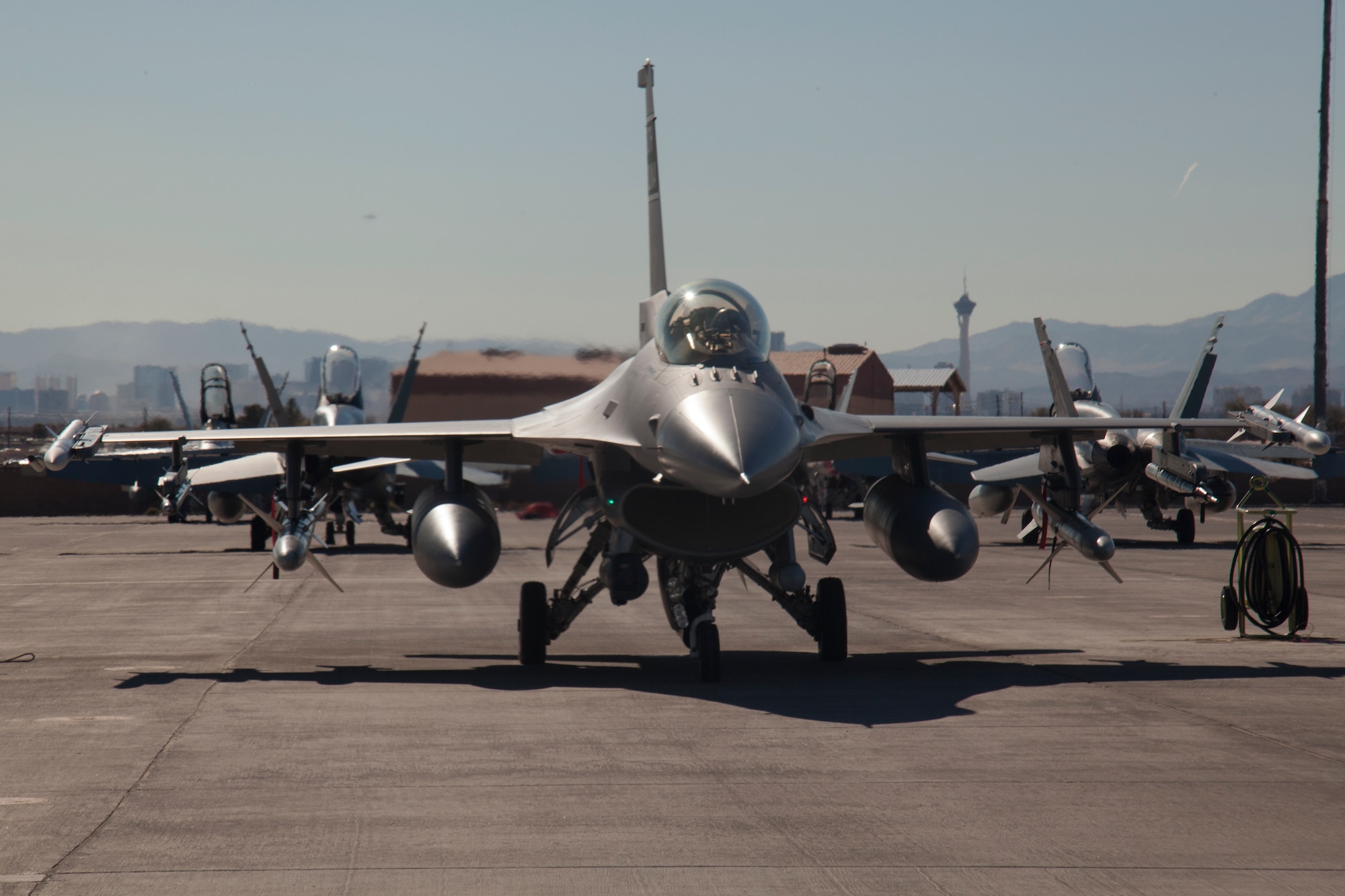 An F-16 Fighting Falcon assigned to the 157th Fighter Squadron, McEntire Joint National Guard Base, S.C., is parked on the Nellis Air Force Base flight line Jan. 26, 2016, during exercise Red Flag 16-1. F-16 Fighting Falcons, along with approximately 30 other airframes, are participating in the advanced training program administered by the United States Warfare Center and executed through the 414th Combat Training Squadron, both located at Nellis Air Force Base. (U.S. Air Force photo by Master Sgt. Burt Traynor/Released)
