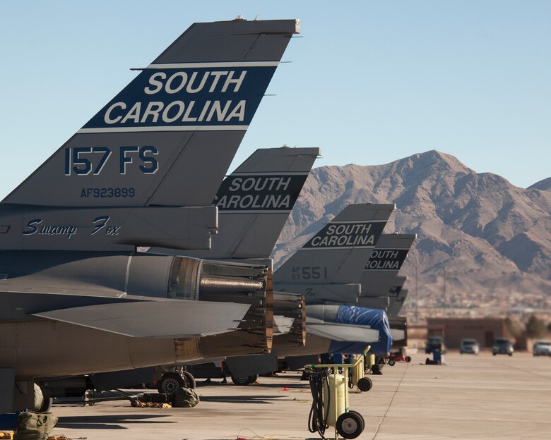 F-16 Fighting Falcons from the 157th Fighter Squadron, McEntire Joint National Guard Base, S.C., await the first sortie of the day Jan. 26, 2016, during exercise Red Flag 16-1 at Nellis Air Force Base, Nev. Nicknamed the “Swamp Foxes,” the 157th FW is participating in the three-week long exercise that provides realistic combat training to maximize the combat readiness and survivability of participants by providing a realistic training environment. (U.S. Air Force photo by Master Sgt. Burt Traynor/Released)