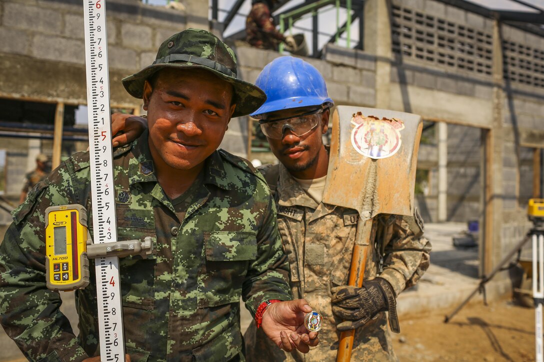 Royal Thai Army Sgt. Frankie Praharn (left), engineer, with the 52nd Engineer Battalion, 1st Regiment Kings Guard and U.S. Army Pfc. Quinton McKnight (right), plumber, with the 643rd Engineer Company, 84th Battalion, a Columbus, Mississippi native, pose for a photograph, during exercise Cobra Gold 2016, in Lop Buri, Thailand, Jan. 30, 2016. Cobra Gold 2016, in its 35th iteration, includes a specific focus on humanitarian civic action, community engagement, and medical activities conducted during the exercise to support the needs and humanitarian interests of civilian populations around the region.
