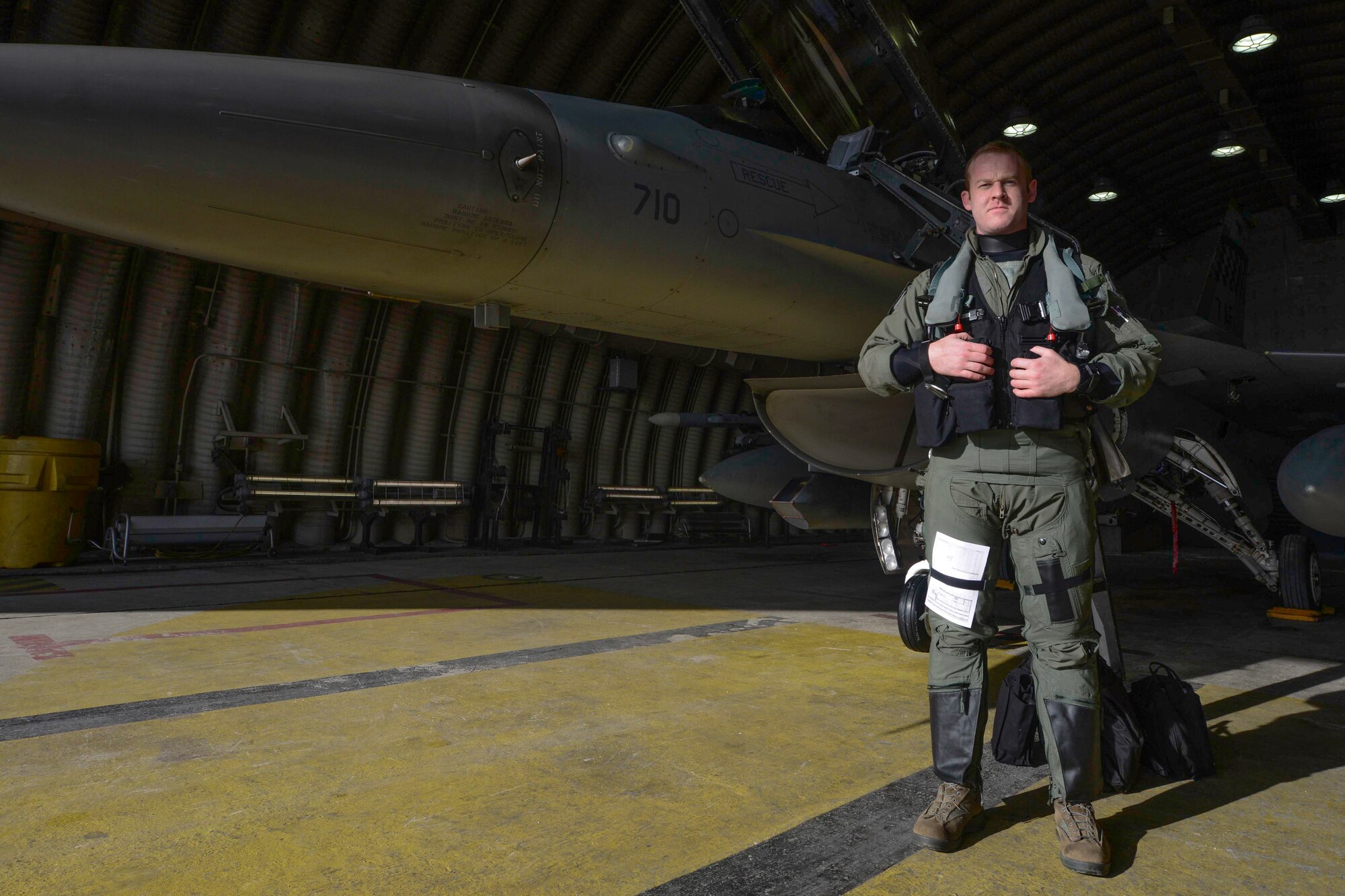 Capt. Nathan Skavdal, 36th Fighter Squadron pilot, poses for a photo with an F-16 Fighting Falcon before takeoff at Osan Air Base, Republic of Korea, Jan. 22, 2016. Skavdal and other 36th FS pilots train with the ROK air force to protect the ROK through deterrence. (U.S. Air Force photo by Airman 1st Class Dillian Bamman/Released)