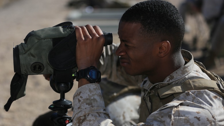 Corporal Robert Ellis, rifleman, 3rd Battalion, 4th Marines, 7th Marine Regiment, spots targets for his shooter during the Designated Marksman Course’s culminating event at Range 113, Jan. 28, 2016. This is the first time a designated marksman course is being held aboard the Combat Center utilizing the Infantry Automatic Rifle. 