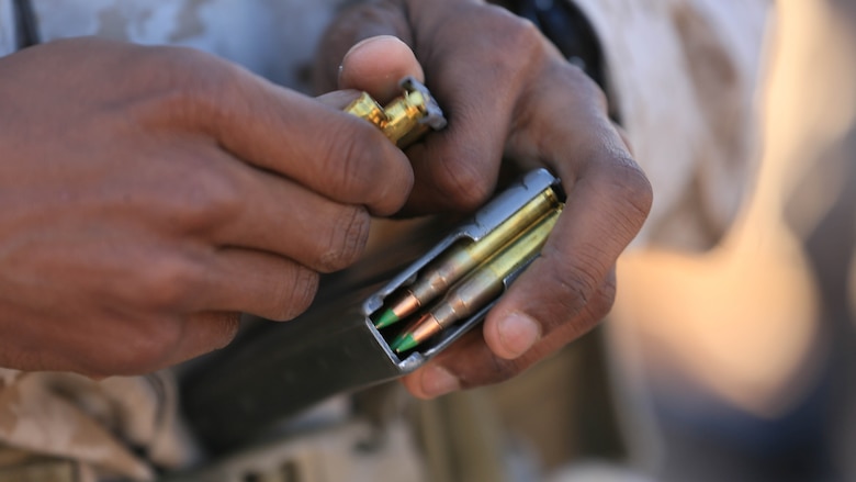 Corporal Robert Ellis, rifleman, 3rd Battalion, 4th Marines, 7th Marine Regiment, loads an M27 Infantry Automatic Rifle magazine with 5.56 mm rounds during the Designated Marksman Course’s culminating event at Range 113, Jan. 28, 2016.