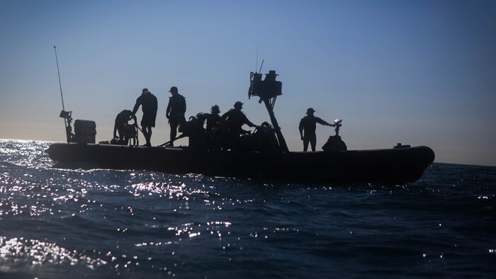 Marines assigned to Company A, 1st Reconnaissance Battalion, 1st Marine Division, and sailors with Assault Craft Unit One, Naval Beach Group One, wait aboard a rigid-hulled inflatable boat for Marines practicing diving techniques off the coast of California, Jan. 28, 2016. The Marines and Sailors will use their dive ability to give the 11th Marine Expeditionary Unit a valuable underwater search tool when it deploys later this year.