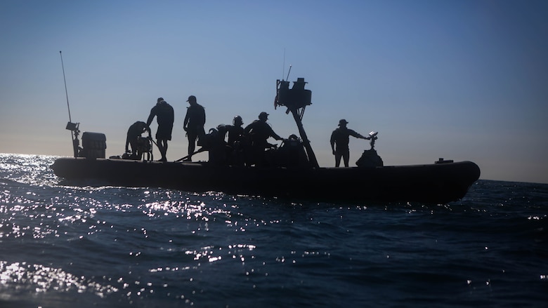 Marines assigned to Company A, 1st Reconnaissance Battalion, 1st Marine Division, and sailors with Assault Craft Unit One, Naval Beach Group One, wait aboard a rigid-hulled inflatable boat for Marines practicing diving techniques off the coast of California, Jan. 28, 2016. The Marines and Sailors will use their dive ability to give the 11th Marine Expeditionary Unit a valuable underwater search tool when it deploys later this year.