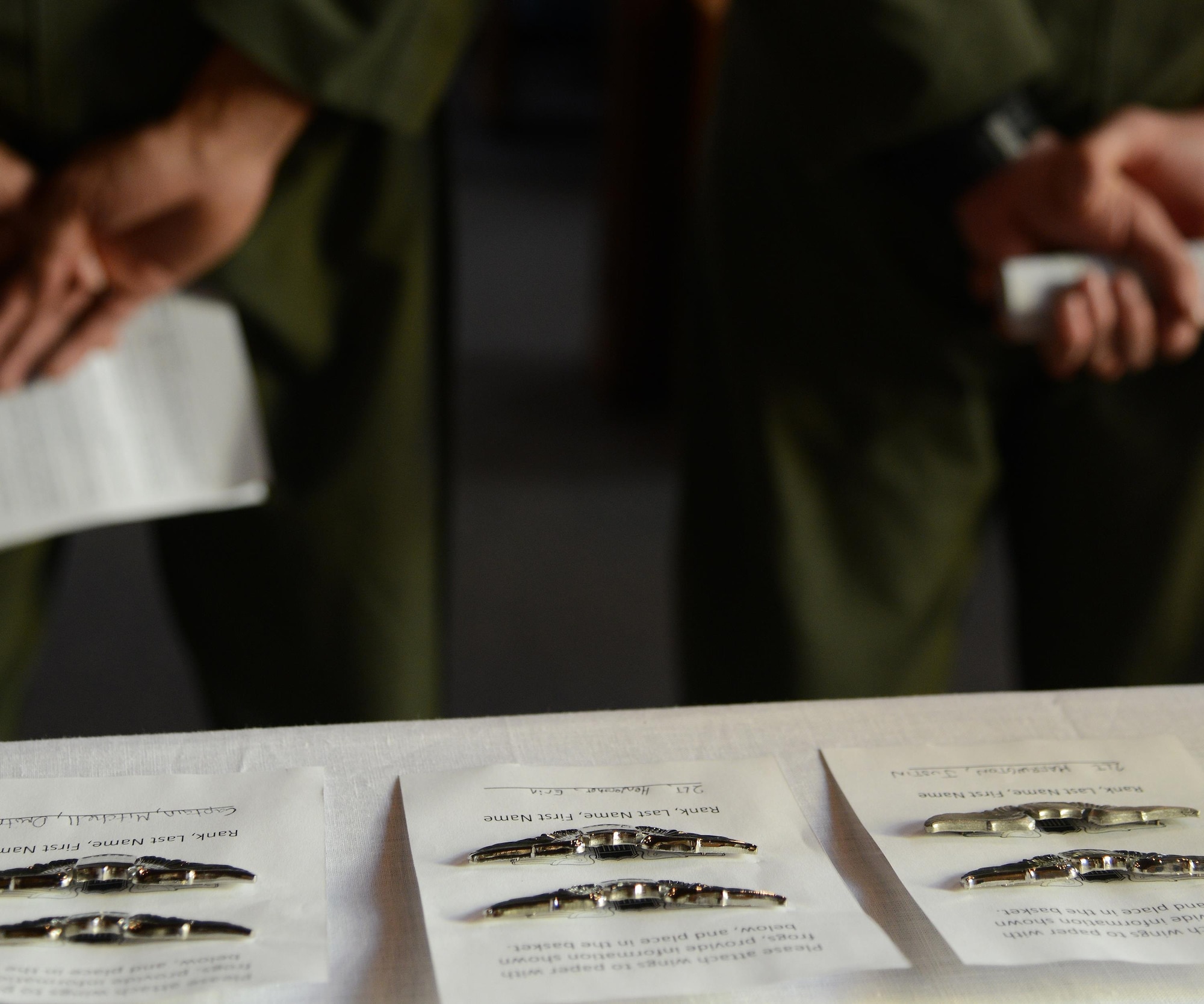 Specialized Undergraduate Pilot Training Class 16-04’s aviation wings sit on a table at the Laughlin Chapel on Laughlin Air Force Base, Texas, Jan. 21, 2016. The Breaking of the Wings tradition goes all the way back to the days of the Army Air Corps and is growing here at Laughlin as class 16-04 celebrated the first-ever Blessing of the Wings ceremony is celebrated. (U.S. Air Force photo by Senior Airman Ariel D. Partlow)