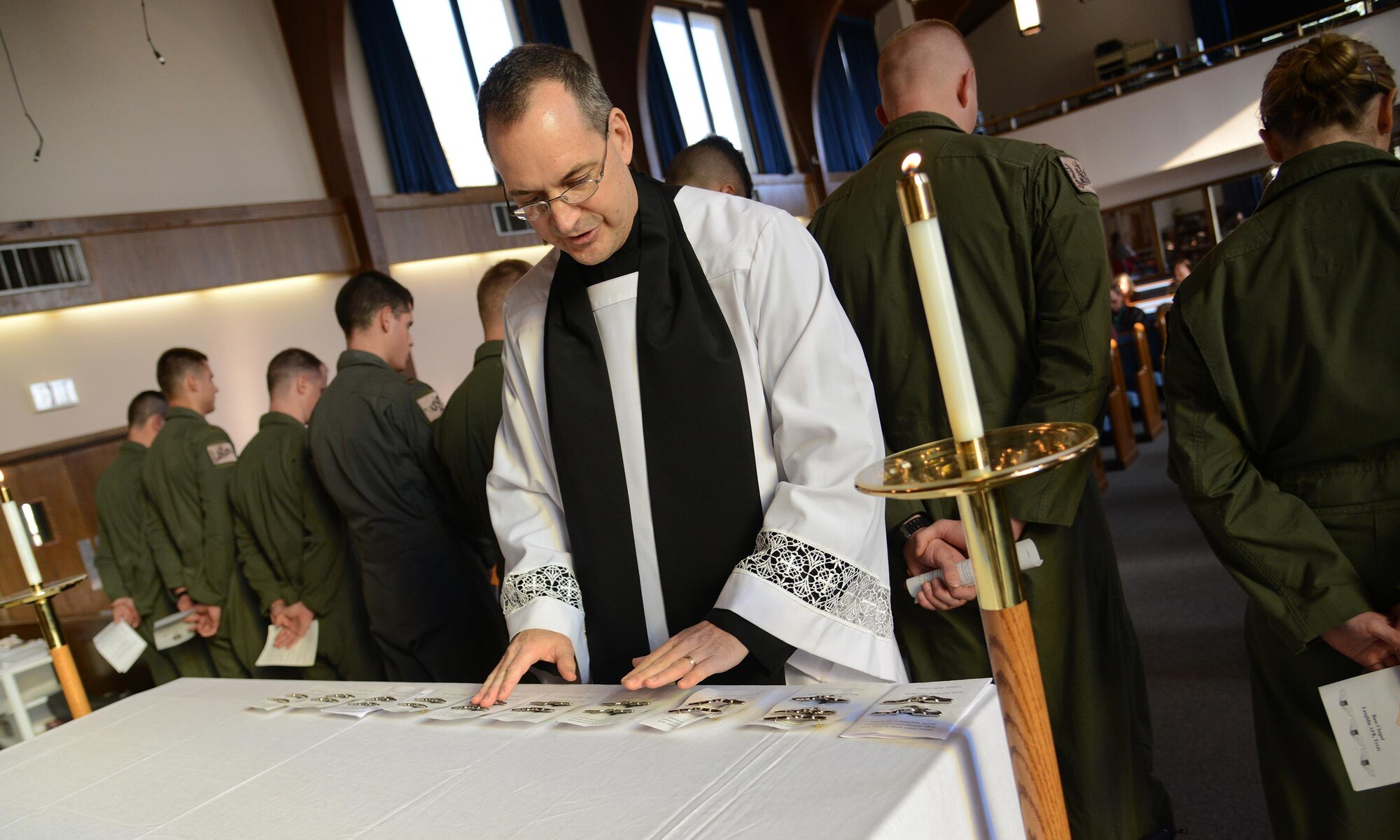 Chap. (Maj.) Richard Beyea, 47th Flying Training Wing chaplain, blesses aviation wings at the Laughlin Chapel on Laughlin Air Force Base, Texas, Jan. 21, 2016. Starting with SUPT class 16-04, the base chapel staff will begin blessing the pilot training graduates’ first pair of wings. (U.S. Air Force photo by Senior Airman Ariel D. Partlow)