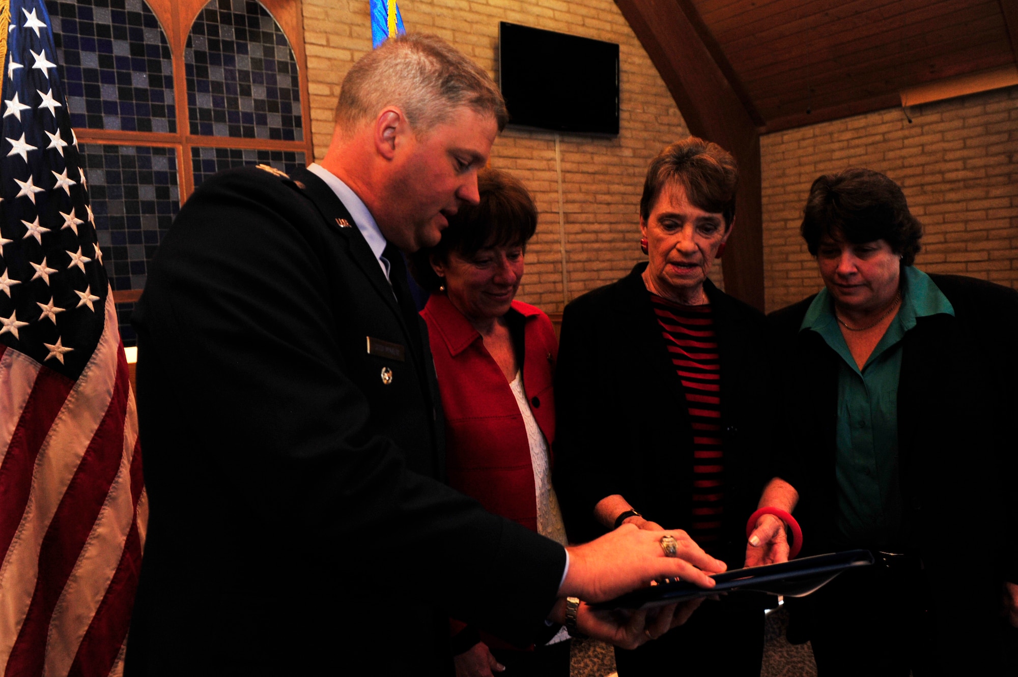 FROM LEFT: Col. David Shoemaker, 56th Fighter Wing vice commander, presents Judy Webster, daughter, Andi Dice, wife, Tamara Dice, daughter, with the Distinguished Flying Cross on behalf of her husband, Maj. Carl Dice, Jan. 27 at Luke Air Force Base. Major Dice received the DFC for extraordinary heroism and aerial achievement displayed during an F-105F combat mission Dec. 8, 1969, into Laos where he lost his life in an attempt to land his combat-damaged aircraft.