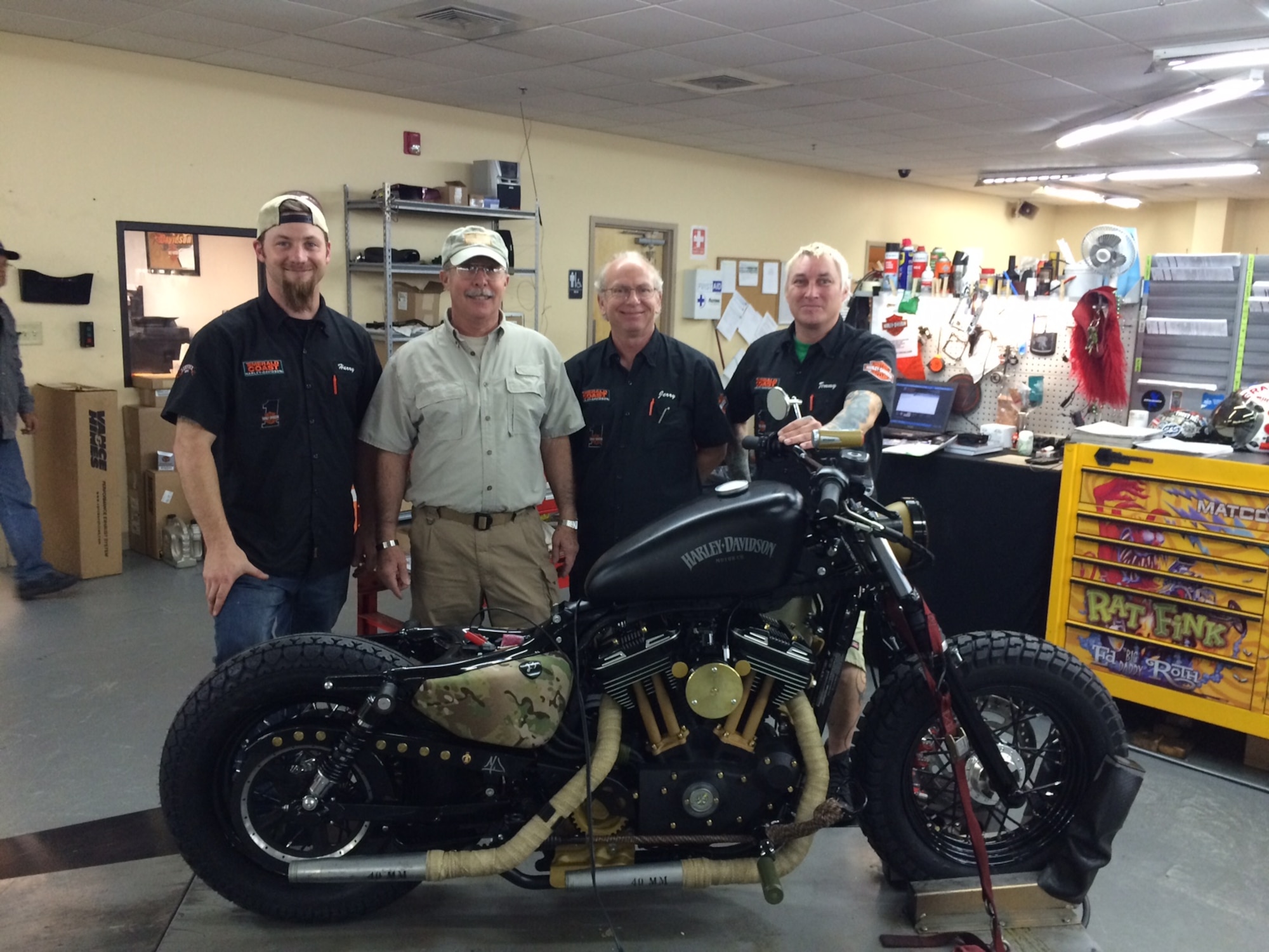 Mark Roland, father of Capt. Matthew Roland, poses with the motorcycle build team at the Emerald Coast Harley-Davidson. The local dealer is building a bike honoring the Special Tactics community, specifically Roland, a Special Tactics Officer from the 23rd Special Tactics Squadron, Hurlburt Field, Fla., who was killed in action in 2015. The motorcycle was part of a company competition for custom bikes, and will be a tribute to the sacrifice and legacy of the Air Force's ground special operators. (Courtesy Photo/Released)
