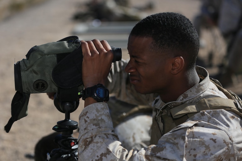 Corporal Robert Ellis, rifleman, 3rd Battalion, 4th Marines, 7th Marine Regiment, spots targets for his shooter during the Designated Marksman Course’s culminating event at Range 113, Jan. 28, 2016. This is the first time a designated marksman course is being held aboard the Combat Center utilizing the Infantry Automatic Rifle. (Official Marine Corps photo by Cpl. Julio McGraw/Released)