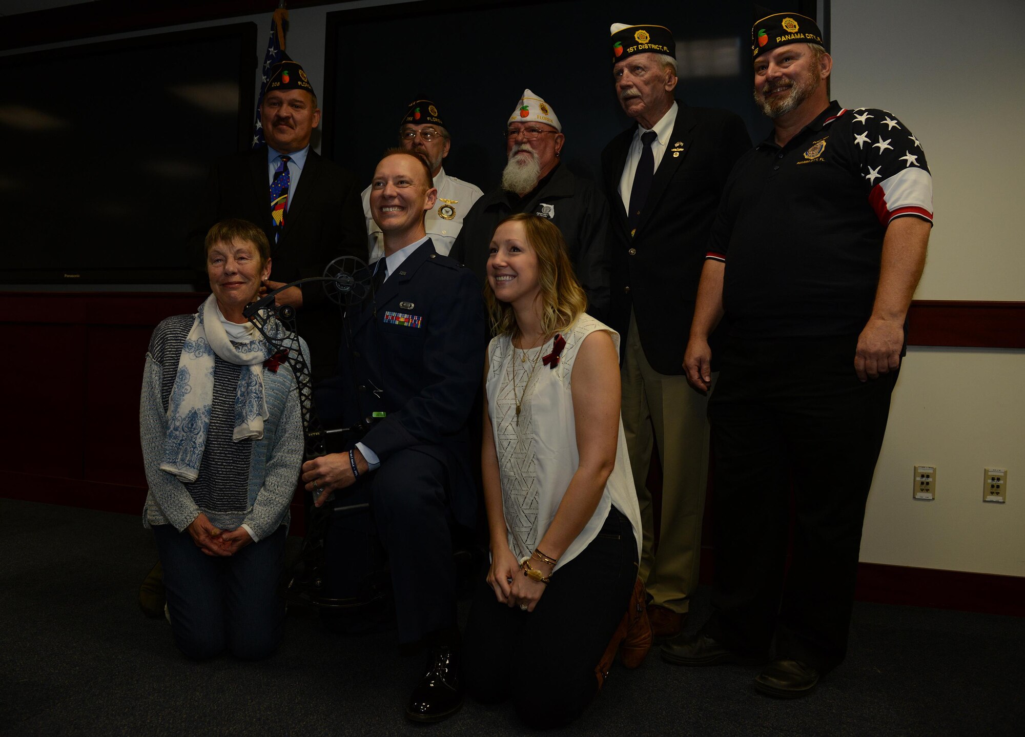 Capt. Chris Cochrane poses for a group photo with his family and the Florida Legionnaires during a presentation ceremony at Hurlburt Field, Fla., on Jan 28, 2016. Cochrane, who suffered a stroke in 2013 that left him paralyzed on his right side, recieved a adaptive compound bow. Cochrane, with his new bow, plans to participate in the upcoming Air Force Wounded Warrior trails at Nellis Air Force Base, Nev., in February. (U.S. Air Force photo/Chief Master Sgt. Quinton T. Burris) 