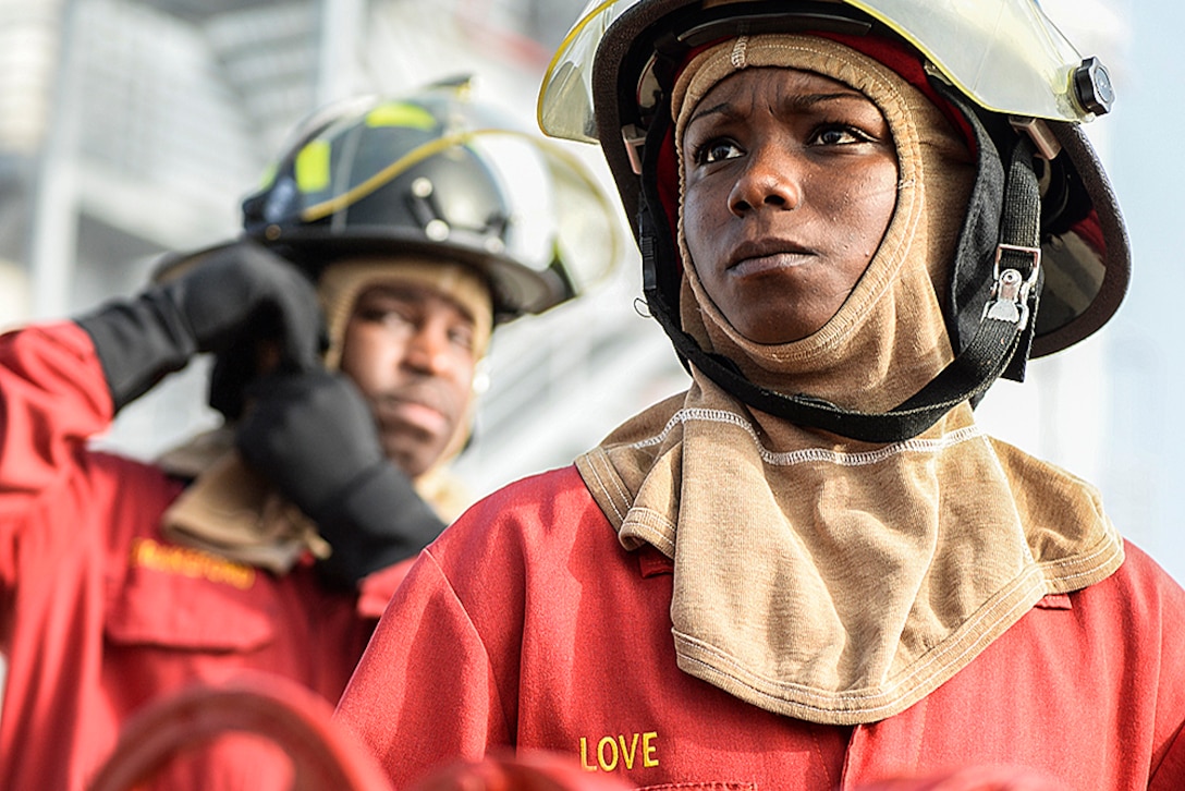 Navy Petty Officer 1st Class Biunca Love prepares to help lead a shipboard aircraft firefighting training event at the firefighting training facility at Naval Station Mayport, Fla., Feb. 2, 2016.  The facility trains sailors attached to ships and components based in Mayport on hose handling, communication procedures and the responsibilities of each member of a hose team. Navy photo by Petty Officer 2nd Class Timothy Schumaker