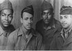 Members of C Company, 514th Truck Regiment.  From left, James H. Bailey, Clarence Bainsford, Jack R. Blackwell, and John R. Houston. John Houston is the father of the late singer/actress Whitney Houston, and runs a company created by her. (Courtesy of the U.S. Army Transportation Museum)