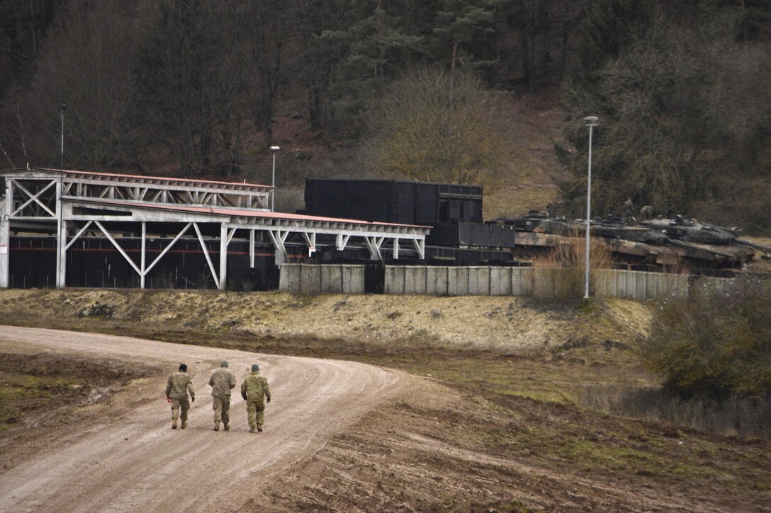 Soldiers approach the tactical vehicle fuel point while participating in maintenance and general upkeep of their engineer vehicles during the unit's participation in Allied Spirit IV in Hohenfels, Germany, Jan. 28, 2016. Army photo by Sgt. William A. Tanner
