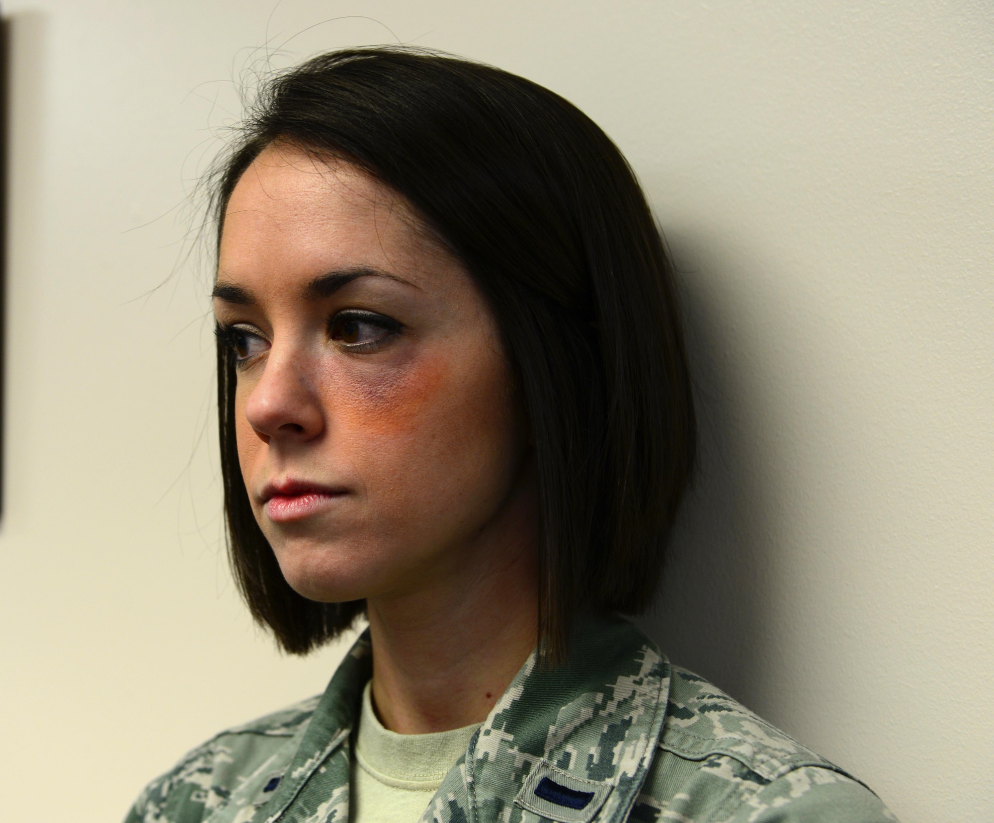 1st Lt. Kelly Wheeler, 354th Medical Group nurse, don’s a bruise to her eye Jan. 21, 2016, at Eielson Air Force Base, Alaska. Wheeler volunteered to adorn the bruise to raise awareness for domestic violence during the “Thanks for Asking” campaign. (U.S. Air Force photo by Airman 1st Class Cassandra Whitman/Released)