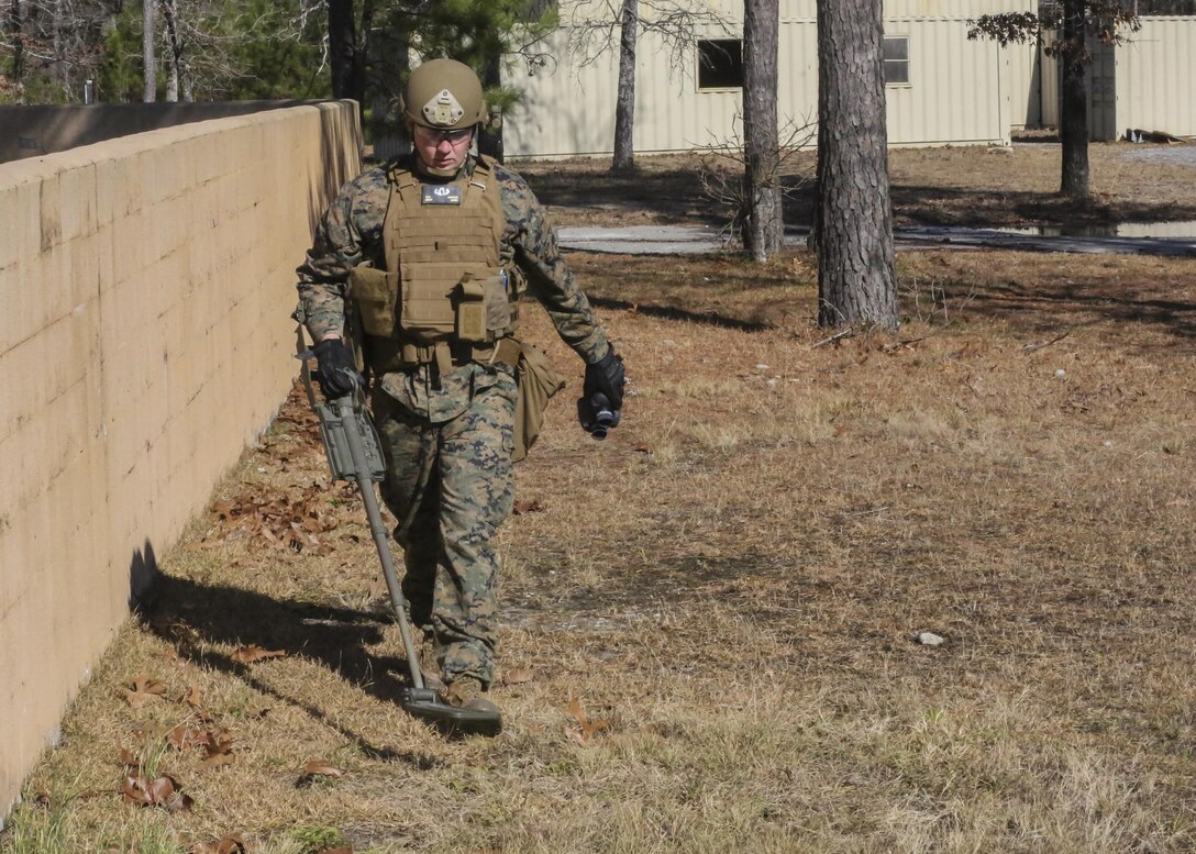 Staff Sgt. Chaz Carter, an Explosive Ordnance Disposal technician with EOD Company, 8th Engineer Support Battalion, searches the area during an improvised explosive device access training exercise aboard Camp Lejeune, N.C., Jan. 29, 2016. During the exercise, evaluators assessed Marines on safely locating and disposing of an IED while suppressing the full capabilities of the threat. (U.S. Marine Corps photo by Lance Cpl. Aaron K. Fiala/Released)