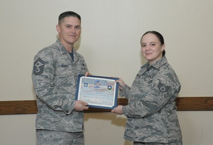 Senior Master Sgt. Terry Gilbert, Headquarters Air Force Public Affairs Agency first sergeant, presents Staff Sgt. Michelle Patten, AFPAA operation cell technician, with a Diamond Sharp Award Jan. 29 at Joint Base San Antonio-Randolph.