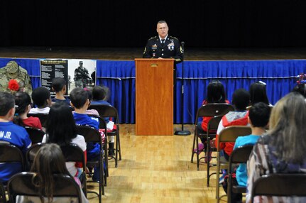 Sgt. 1st Class David E. Lovett, a member of the Surgeon's Office for the U.S. Army Reserve's 99th Regional Support Command headquartered at Joint Base McGuire-Dix-Lakehurst, N.J., speaks to children Feb. 3 at the Immaculate Conception Elementary School in Spotswood, N.J., during the school's Patriotic Day.
