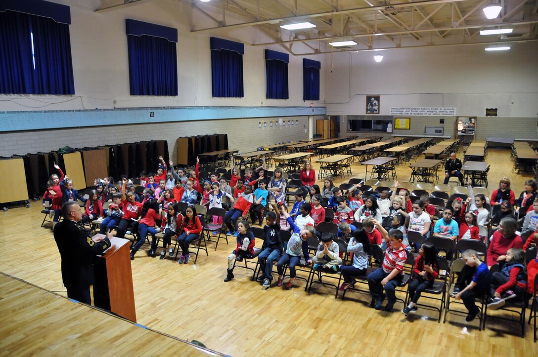 Sgt. 1st Class David E. Lovett, a member of the Surgeon's Office for the U.S. Army Reserve's 99th Regional Support Command headquartered at Joint Base McGuire-Dix-Lakehurst, N.J., speaks to children Feb. 3 at the Immaculate Conception Elementary School in Spotswood, N.J., during the school's Patriotic Day.