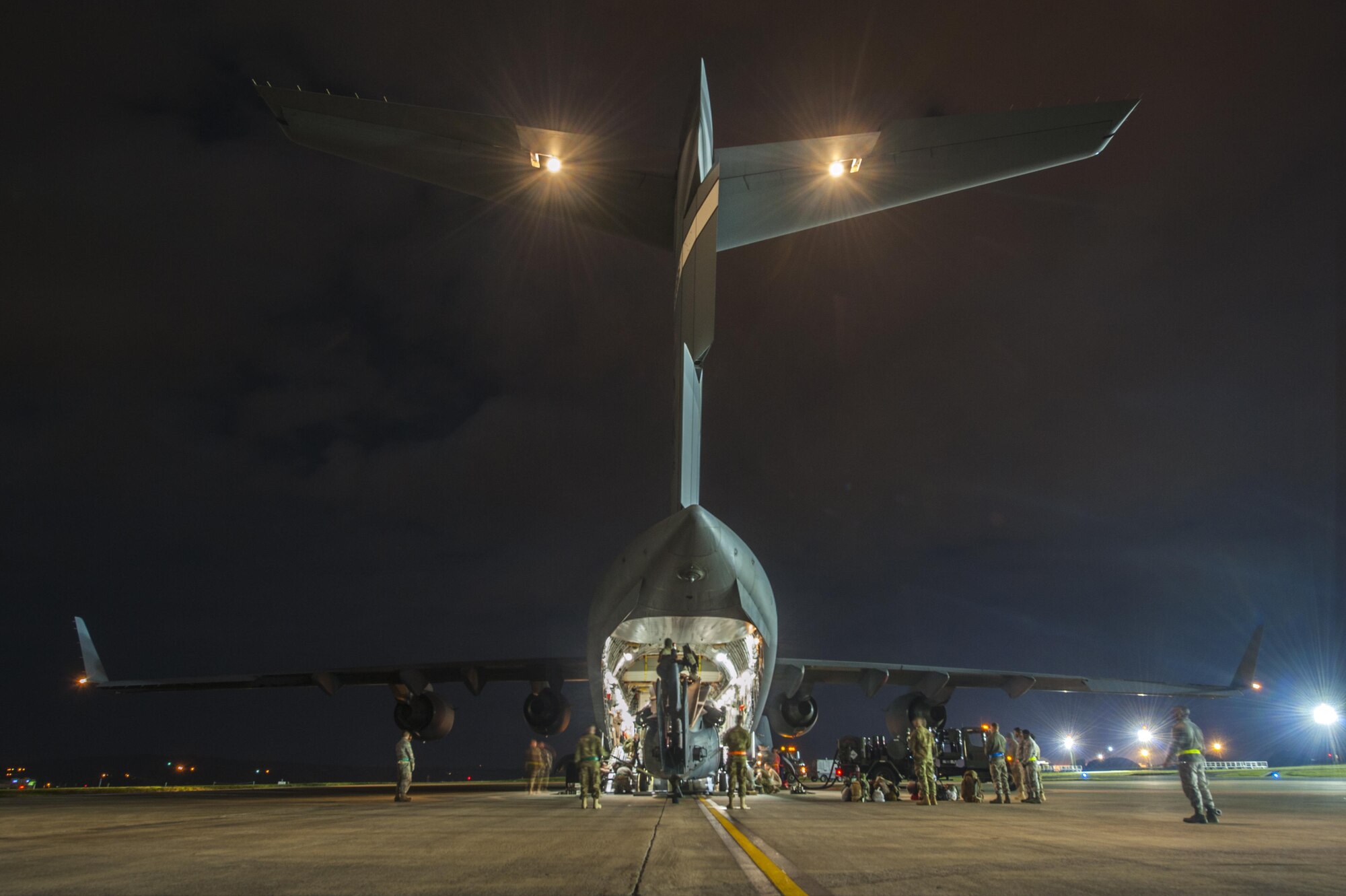 Members of the 33rd Helicopter Maintenance Unit load an HH-60 Pave Hawk onto a C-17 Globemaster III, Jan. 26, 2016, at Kadena Air Base. The HH-60 is the U.S. Air Force’s primary search and rescue helicopter used by special tactics teams and pararescuemen. (U.S. Air Force photo by Airman 1st Class Nick Emerick/Released)