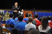 Lt. Col. Julian R. Nierva, deputy staff judge advocate for the U.S. Army Reserve's 99th Regional Support Command headquartered at Joint Base McGuire-Dix-Lakehurst, N.J., speaks to children Feb. 3 at the Immaculate Conception Elementary School in Spotswood, N.J., during the school's Patriotic Day.
