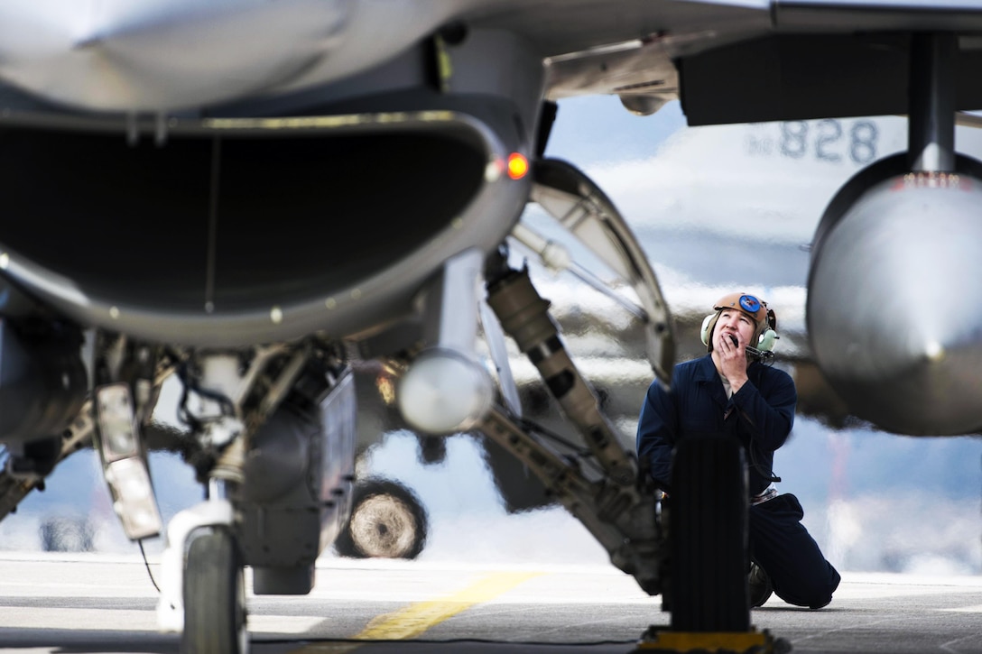 Air Force Staff Sgt. Ryan Anderson performs preflight checks on an F-16 Fighting Falcon fighter aircraft during a training exercise at Souda Bay, Greece, Jan. 27, 2016. Airmen from U.S. and Greek forces participate in the multinational training exercise. Anderson is a crew chief assigned to the 480th Expeditionary Fighter Squadron. Air Force photo by Staff Sgt. Christopher Ruano