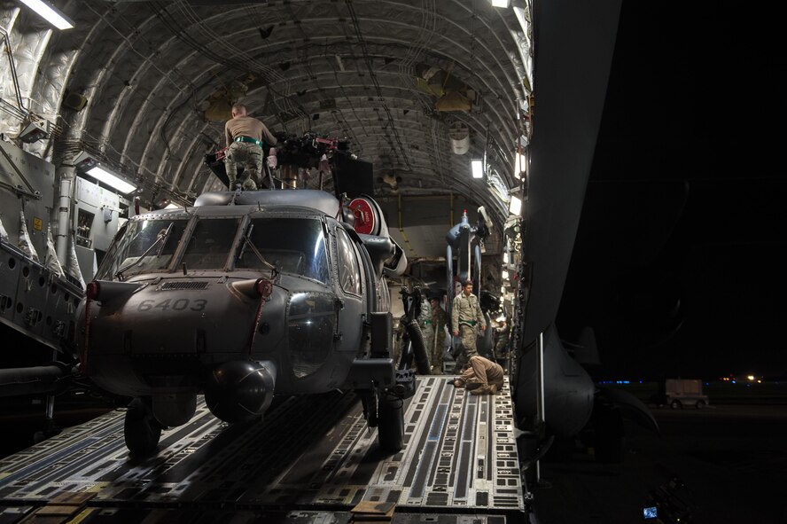 U.S. Air Force Airmen with the 33rd Helicopter Maintenance Unit load an HH-60 Pave Hawk into a C-17 Globemaster III Jan 26, 2016, on the flight line at Kadena Air Base, Japan. The C-17 is capable of rapid strategic delivery of troops and all types of cargo to main operating bases or directly to forward bases in the deployment area. (U.S. Air Force photo by Airman 1st Class Nick Emerick/Released)