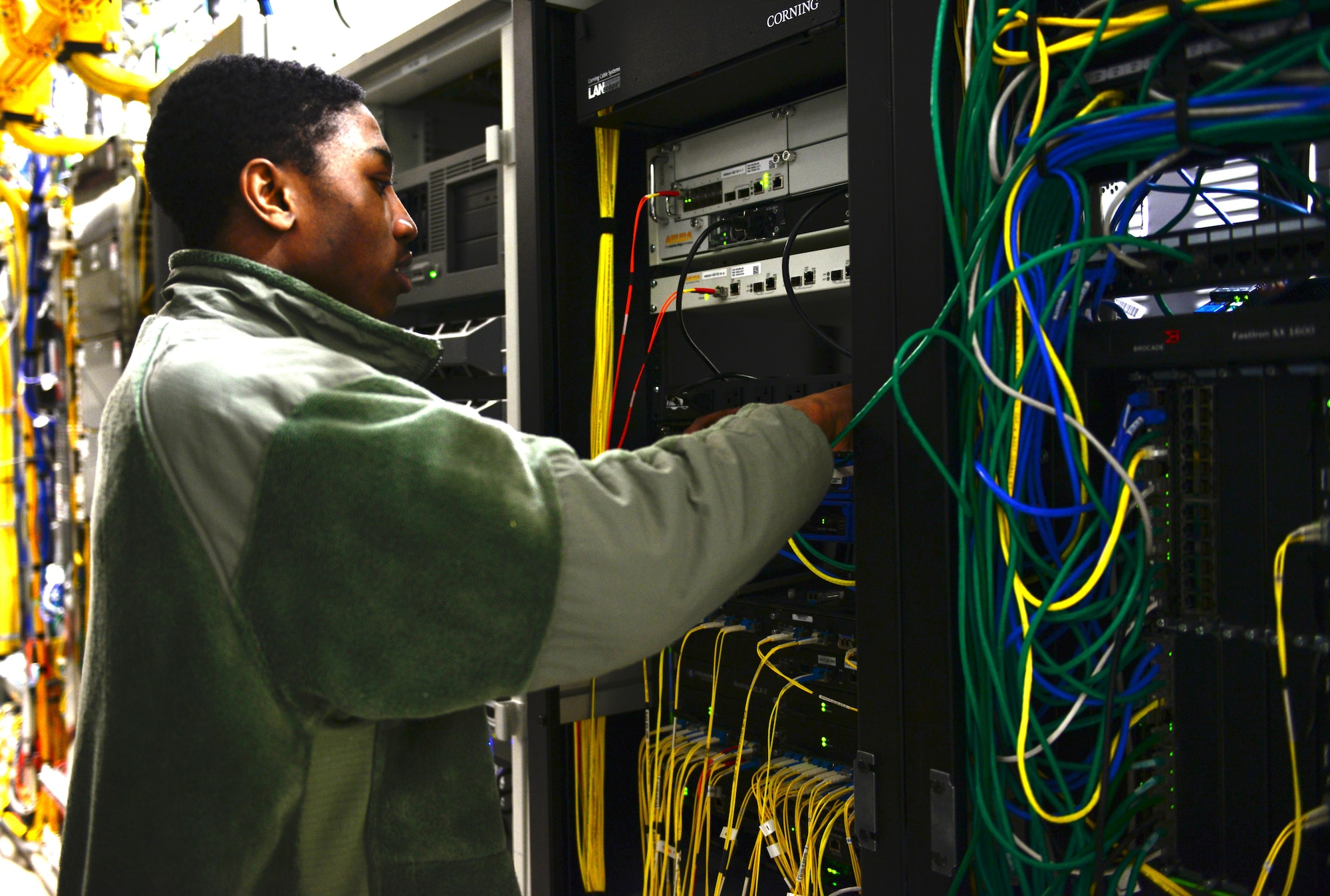 U.S. Air Force Airman 1st Class Angelo Dickerson, 354th Communications Squadron cyber transport systems technician, connects wires Jan. 27, 2016, at Eielson Air Force Base, Alaska. This wire system is where Dickerson physically connects users across the base to the network. (U.S. Air Force photo by Airman 1st Class Cassandra Whitman/Released)