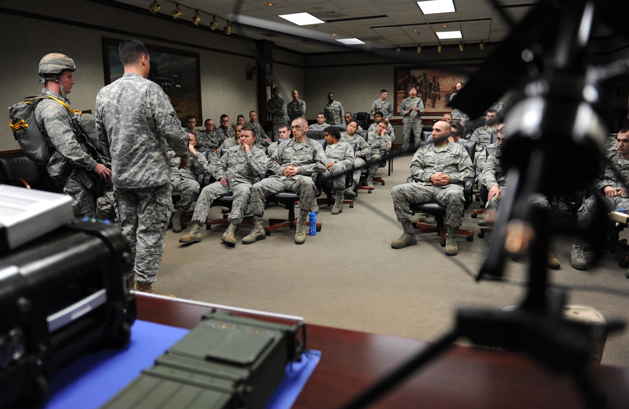 Second Lt. Nicholas Arbour, 333rd Training Squadron undergraduate cyber student, showcases a fully combat equipped MC-6 parachute as U.S. Army Capt. Eric Stell, Joint Communications Support Element troop commander, MacDill Air Force Base, Fla., conducts an equipment capabilities presentation at Stennis Hall Feb. 2, 2016, Keesler Air Force Base, Miss. Joint Communications Support Element provides rapidly deployable, scalable, en-route and early entry communications capabilities across the full spectrum of operations in order to enable rapid action of the joint force. (U.S. Air Force photo by Kemberly Groue)