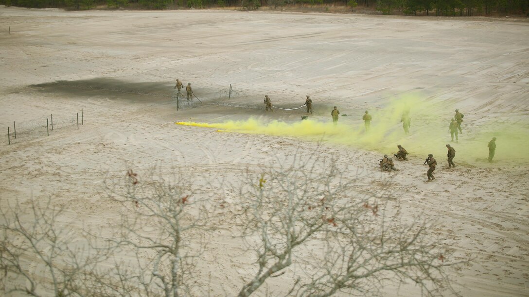 Marines with 2nd Combat Engineer Battalion prepare a live charge during the assault breacher’s portion of the Sapper leader’s course at Camp Lejeune, N.C., Jan. 28, 2016. The three-week long course trains the Marines to be more proficient at patrolling, demolitions and demolition breaching. (U.S. Marine Corps photo by Cpl. Joey Mendez)