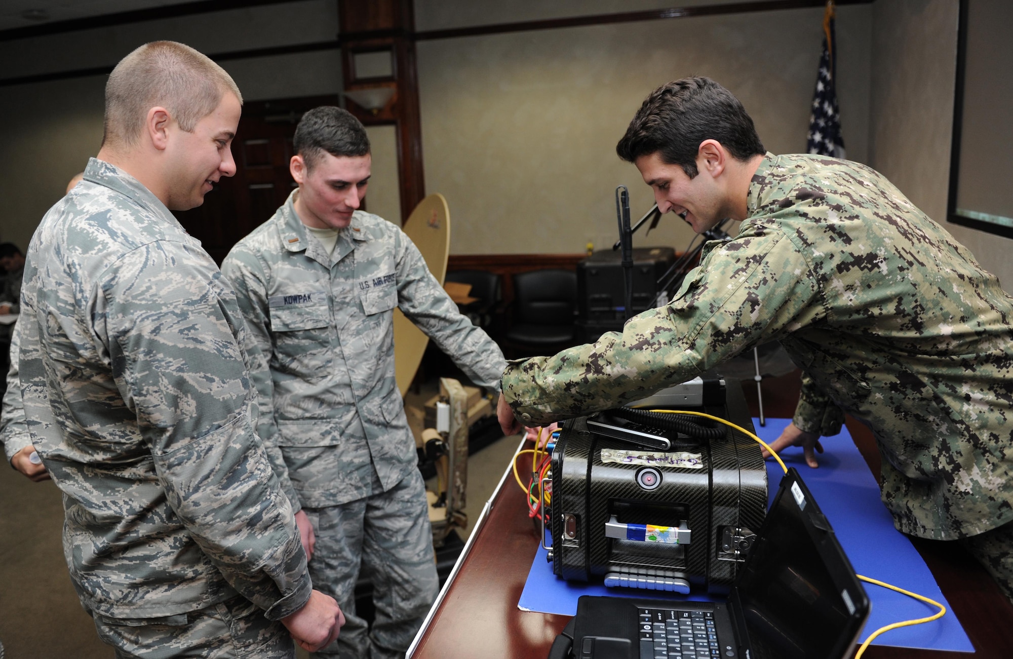 Second Lts. Nicholas Taylor and Michael Kowpak, 333rd Training Squadron undergraduate cyber students, receive an equipment demonstration from U.S. Navy Petty Officer 2nd Class Jacob Yates, Joint Communications Support Element information systems technician, MacDill Air Force Base, Fla., during an equipment capabilities presentation at Stennis Hall Feb. 2, 2016, Keesler Air Force Base, Miss. Joint Communications Support Element provides rapidly deployable, scalable, en-route and early entry communications capabilities across the full spectrum of operations in order to enable rapid action of the joint force. (U.S. Air Force photo by Kemberly Groue)