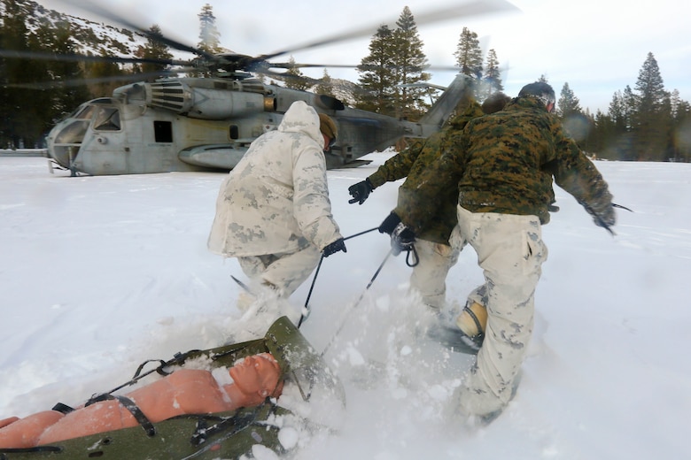 Marines with 2nd Platoon, Alpha Company, 2nd Assault Amphibian Battalion, rush toward a CH-53 Super Stallion with a simulated casualty avalanche victim at the Mountain Warfare Training Center in Bridgeport, Calif., Jan. 20, 2016. Marines across II Marine Expeditionary Force and 2nd Marine Expeditionary Brigade took part in the scenario as part of Mountain Exercise 1-16 in preparation for Exercise Cold Response 16.1 in Norway this March. The exercise will feature military training including maritime, land and air operations that underscore NATO's ability to defend against any threat in any environment. (U.S. Marine Corps photo by Cpl. Dalton A. Precht/released)
