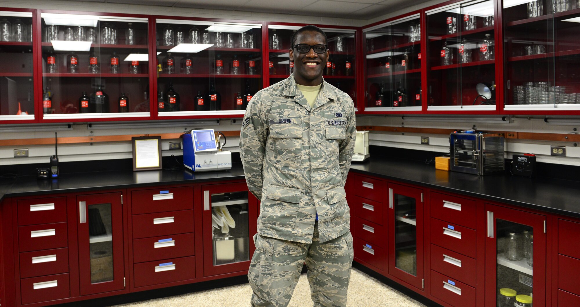 U.S. Air Force Senior Airman Andre Brown, 354th Logistics Readiness Squadron fuels laboratory technician, takes a quick break Jan. 14, 2016 at Eielson Air Force Base, Alaska. Brown stands in the fuels laboratory where he conducts tests on Eielson and Fort Wainwright aircraft fuel. (U.S. Air Force photo by Airman 1st Class Cassandra Whitman/Released)