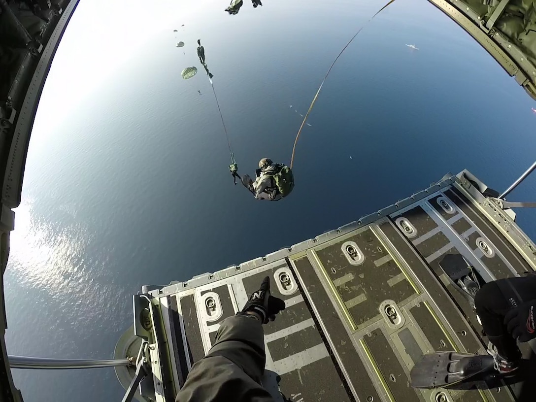 Elements from U.S. Marine Special Operations Raiders and Navy SEALs conduct a Low Level Static Line water jump in the waters off the Republic of Korea. Rotational U.S. Special Operations Forces conducted the jump as part of an Emergency Deployment Readiness Exercise into Korea to kick off a combined-special operations-conventional force maritime training event which included elements from the ROK Navy Flotilla and SEALS, Combined Naval Forces Korea, and Special Operations Command Korea. (U.S. MARSOC Photo/Released) 