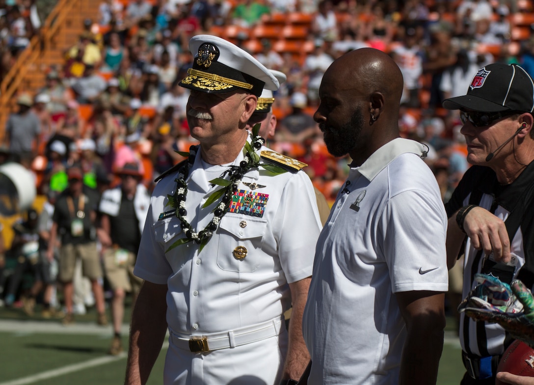 Adm. Scott Swift, U.S. Pacific Fleet, commander and Pro Football Hall of Famer Jerry Rice listen to a referee prior to the coin toss of the 2016 NFL Pro Bowl, at Aloha Stadium in Honolulu, Hawaii, Jan. 31, 2016. This year marks the 35th Pro Bowl held at Aloha Stadium, and commanders from each component command were present for the coin toss.