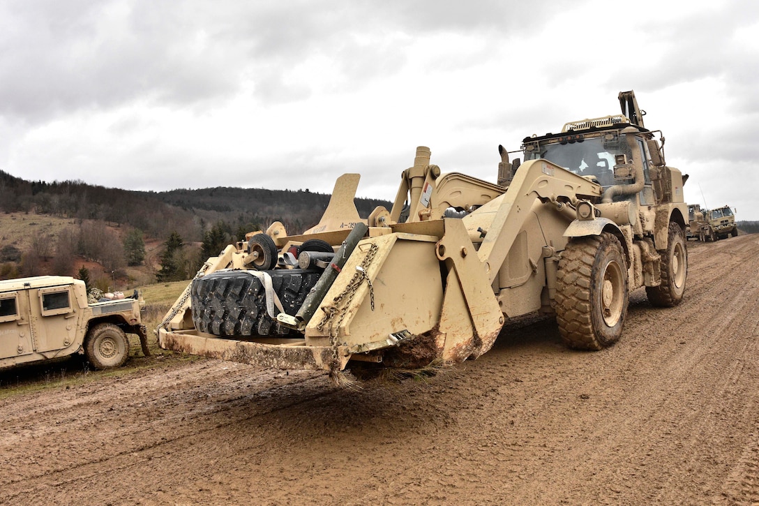 A soldier drives his construction vehicle toward the tactical fuel point while conducting maintenance operations and general upkeep of their vehicles during the unit's participation in Allied Spirit IV in Hohenfels, Germany, Jan. 28, 2016. Army photo by Sgt. William A. Tanner