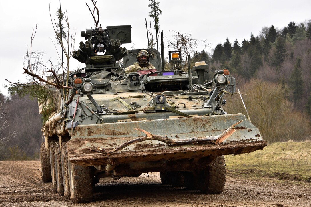 A soldier drives his construction vehicle toward the tactical fuel point while conducting maintenance operations and general upkeep of their vehicles during the unit's participation in Allied Spirit IV in Hohenfels, Germany, Jan. 28, 2016. Army photo by Sgt. William A. Tanner