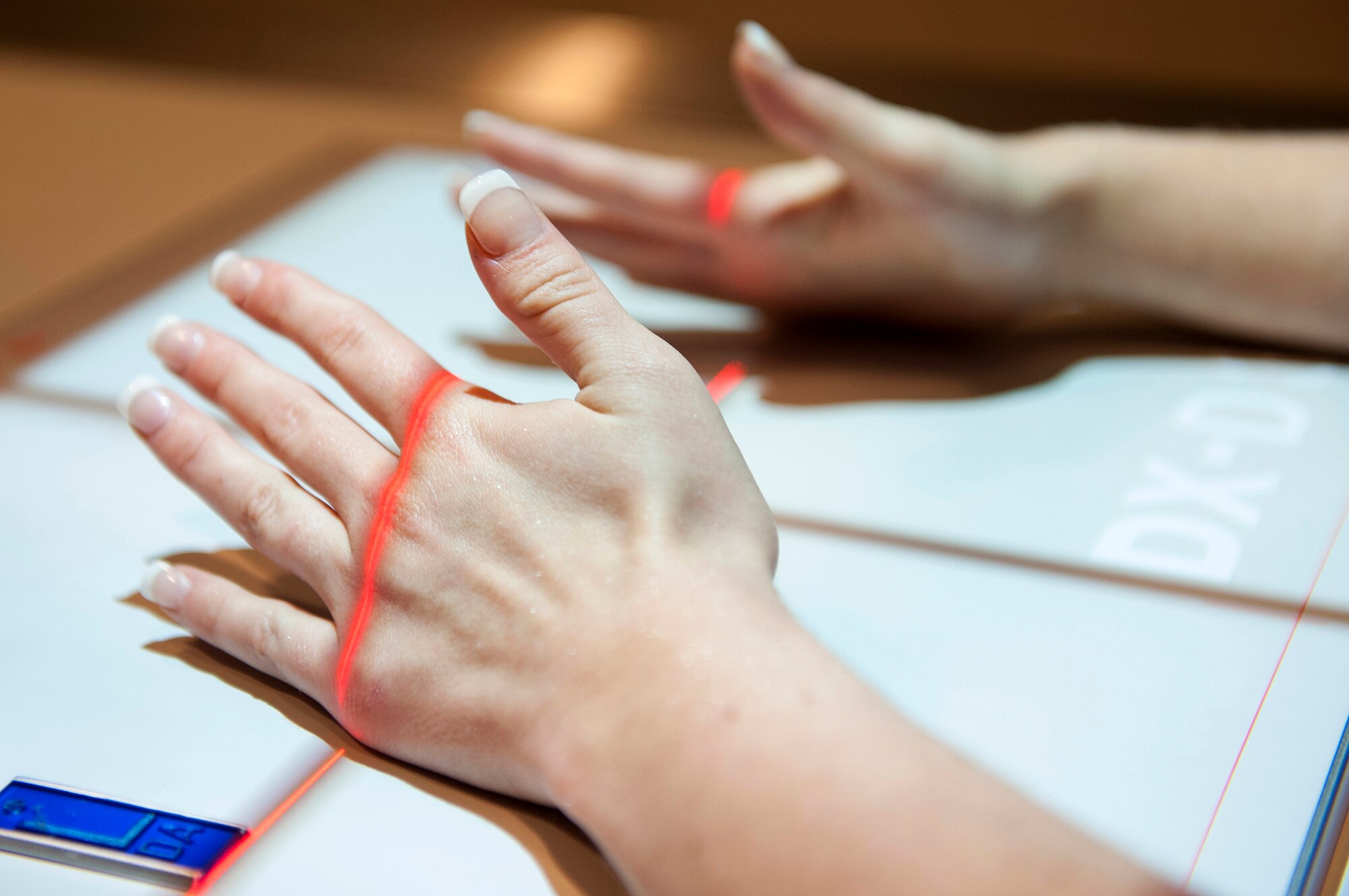 A patient from the 23d Medical Group positions her hands for an X-ray, Feb. 2, 2016, at Moody Air Force Base, Ga. The diagnostic imaging clinic has machines that are capable of capturing X-rays of every bone in the human body. (U.S. Air Force photo by Airman 1st Class Kathleen D. Bryant/Released)
