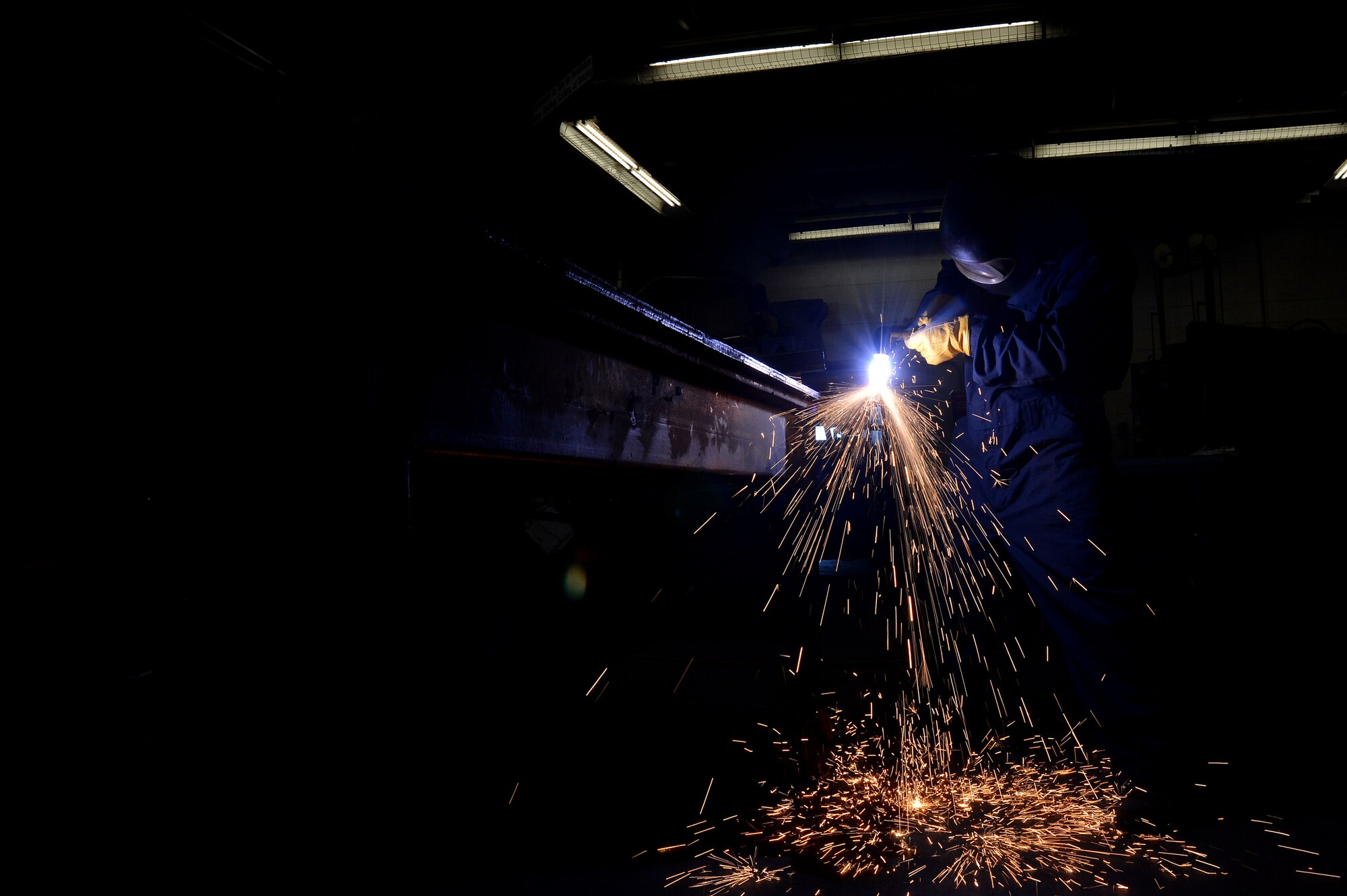 U.S. Air Force Senior Airman John Abbott, 20th Equipment Maintenance Squadron metals technology journeyman, welds a piece of metal using a plasma cutter at Shaw Air Force Base, S.C., Jan. 12, 2016. A plasma cutter can heat up to approximately 10,000 degrees Fahrenheit and can cut metal up to 10 inches thick. (U.S. Air Force photo by Senior Airman Michael Cossaboom)