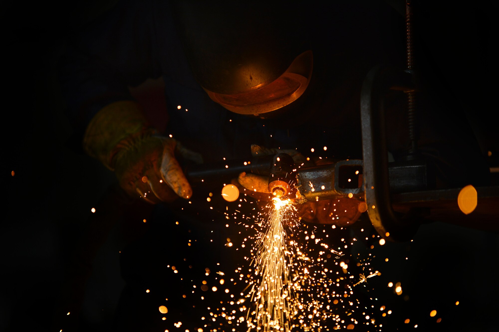 U.S. Air Force Senior Airman John Abbott, 20th Equipment Maintenance Squadron metal technology journeyman, uses a plasma cutter to weld a piece of metal at Shaw Air Force Base, S.C., Feb. 2, 2016. A plasma cutter can heat up to approximately 10,000 degrees Fahrenheit and is used to cut metal up to 10 inches thick. (U.S. Air Force photo by Senior Airman Michael Cossaboom)
