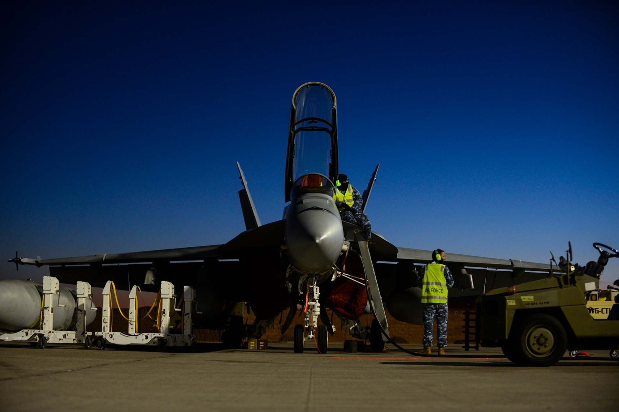 Royal Australian Air Force aircrew assigned to No. 1 Squadron, RAAF Amberley, Australia, perform routine maintenance inspections on an F/A-18 Super Hornet during Red Flag 16-1 at Nellis Air Force Base, Nev., Feb. 2, 2016. Night missions have been integrated into Red Flag to prepare aircrews for missions in low-light environment. (U.S. Air Force photo by Airman 1st Class Nathan Byrnes)