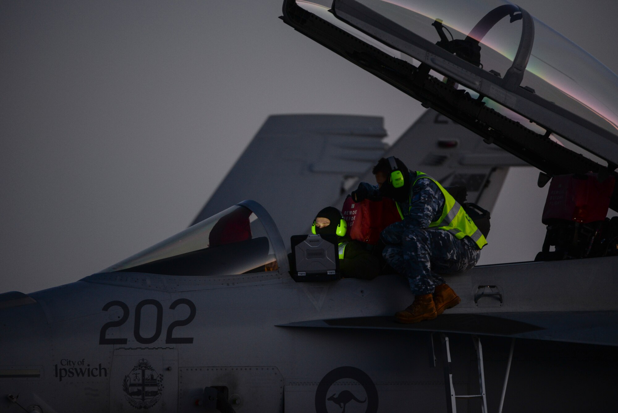 Royal Australian Air Force aircrew assigned to No. 1 Squadron, RAAF Amberley, Australia, perform maintenance checks on an F/A-18 Super Hornet during Red Flag 16-1 at Nellis Air Force Base, Nev., Feb. 2, 2016. Flying units from around the world the globe deploy to Nellis AFB to participate in Red Flag, the exercise is held four times a year and organized by the 414th Combat Training Squadron. (U.S. Air Force photo by Airman 1st Class Nathan Byrnes)