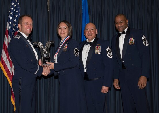 Master Sgt. Kathleen May accepts the 366th Fighter Wing First Sergeant of the Year award from 366th FW Commander Col. David Iverson, (left) 12th Air Force Command Chief Master Sgt. Jose Barraza and (right) 366th FW Command Chief Master Sgt. David Brown, during the Annual Awards Ceremony at Mountain Home AFB, Idaho, Jan. 29, 2016. May is a member of the 366th Operations Group at Mountain Home AFB. (U.S. Air Force photo by Senior Airman Jeremy L. Mosier/Released)