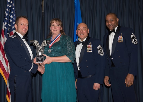 Robin Frank accepts the 366th Fighter Wing Category I Civilian Employee 
of the Year award from 366th FW Commander Col. David Iverson, (left) 12th Air 
Force Command Chief Master Sgt. Jose Barraza and (right) 366th FW Command 
Chief Master Sgt. David Brown, during the Annual Awards Ceremony at Mountain 
Home AFB, Idaho, Jan. 29, 2016. Frank is a member of the 366th Medical Group 
at Mountain Home AFB. (U.S. Air Force photo by Senior Airman Jeremy L. 
Mosier/Released)
