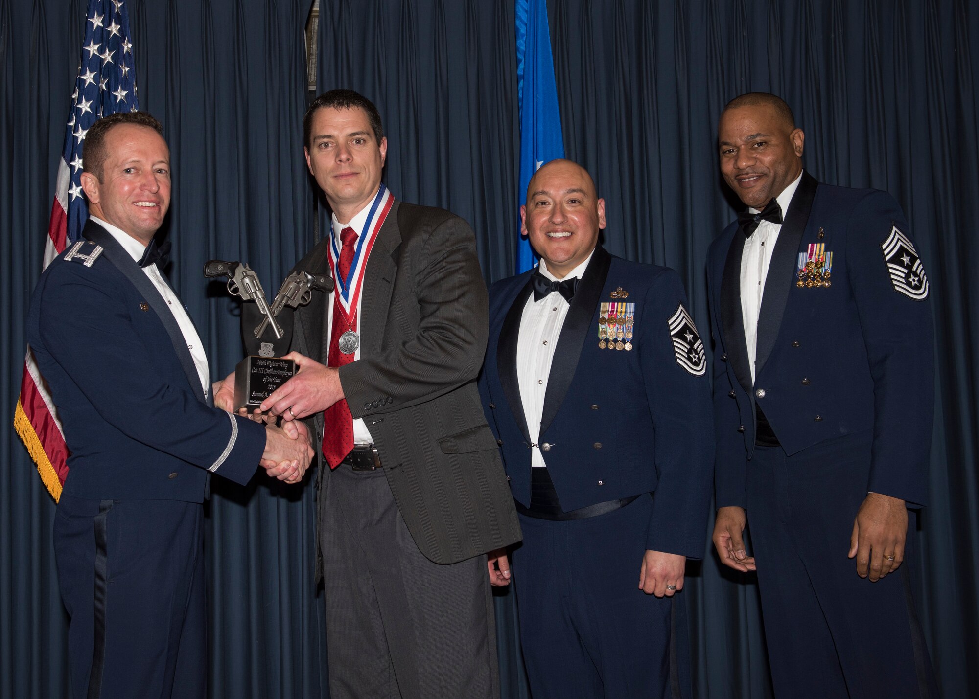 Samuel Shearman III accepts the 366th Fighter Wing Category III Civilian 
Employee of the Year award from 366th FW Commander Col. David Iverson, (left) 
12th Air Force Command Chief Master Sgt. Jose Barraza and (right) 366th FW 
Command Chief Master Sgt. David Brown, during the Annual Awards Ceremony at 
Mountain Home AFB, Idaho, Jan. 29, 2016. Shearman is a member of the 366th 
Mission Support Group at Mountain Home AFB. (U.S. Air Force photo by Senior 
Airman Jeremy L. Mosier/Released)

