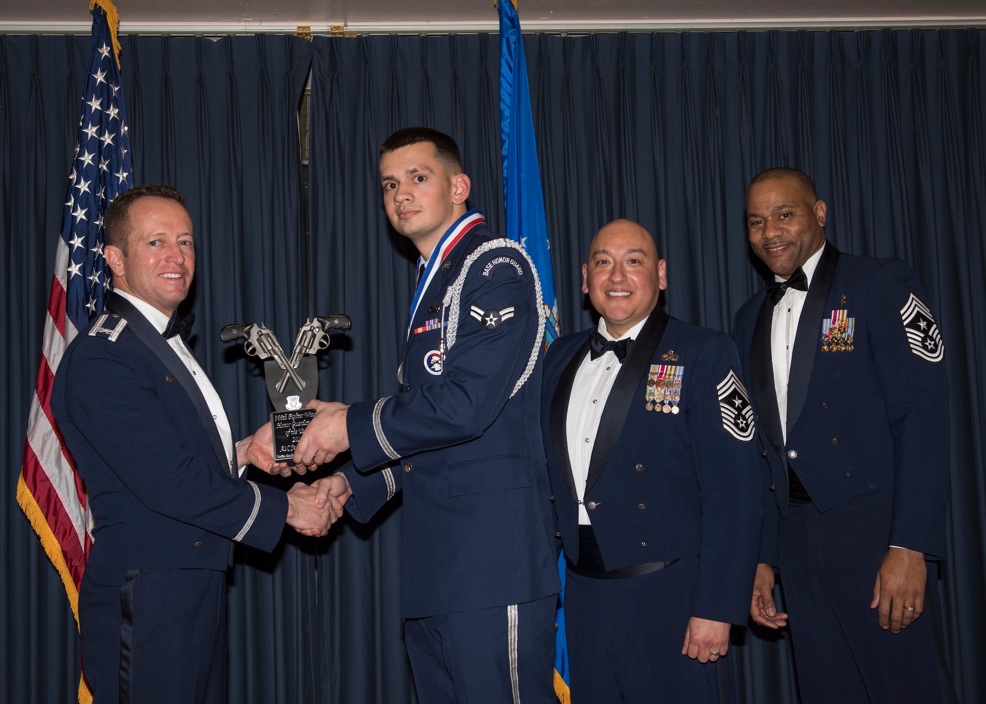 Airman 1st Class Jesse Bridge accepts the 366th Fighter Wing Honor Guardsman of the Year award from 366th FW Commander Col. David Iverson, (left) 12th Air Force Command Chief Master Sgt. Jose Barraza and (right) 366th FW Command Chief Master Sgt. David Brown, during the Annual Awards Ceremony at Mountain Home AFB, Idaho, Jan. 29, 2016. Bridge is a member of the 366th Mission Support Group at Mountain Home AFB. (U.S. Air Force photo by Senior Airman Jeremy L. Mosier/Released)