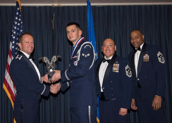 Airman 1st Class Jesse Bridge accepts the 366th Fighter Wing Honor Guardsman of the Year award from 366th FW Commander Col. David Iverson, (left) 12th Air Force Command Chief Master Sgt. Jose Barraza and (right) 366th FW Command Chief Master Sgt. David Brown, during the Annual Awards Ceremony at Mountain Home AFB, Idaho, Jan. 29, 2016. Bridge is a member of the 366th Mission Support Group at Mountain Home AFB. (U.S. Air Force photo by Senior Airman Jeremy L. Mosier/Released)